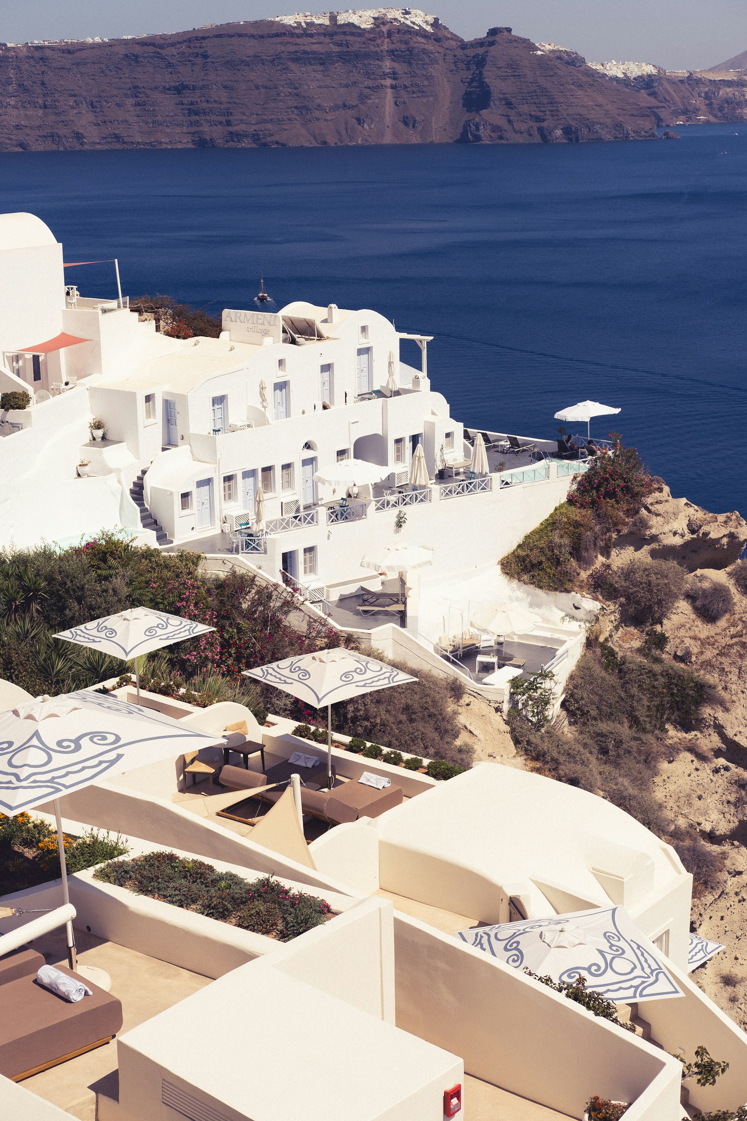 Aerial view of white Cycladic buildings against the Aegean.